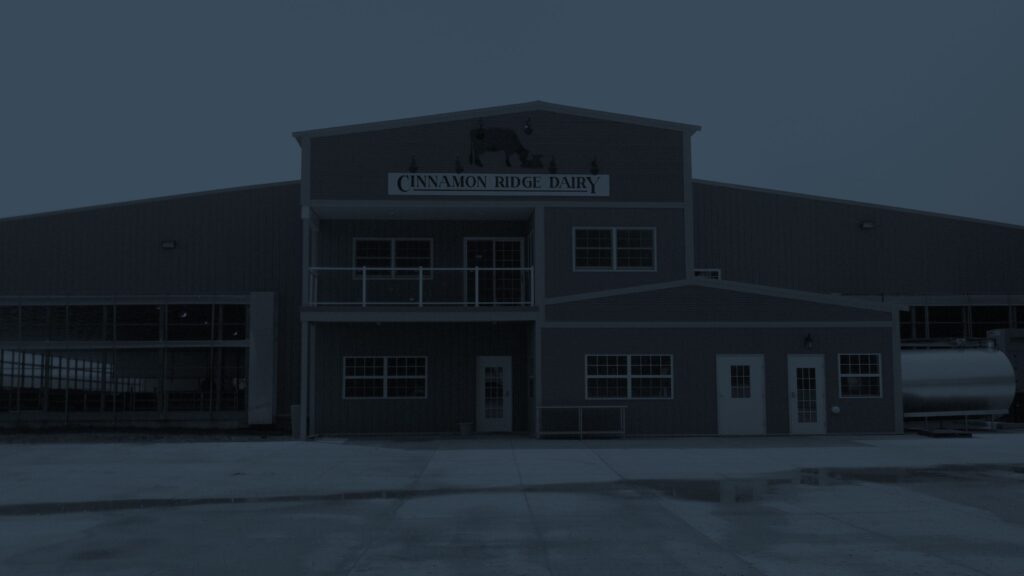Blue overlay photo of Cinnamon Ridge Farms main building.