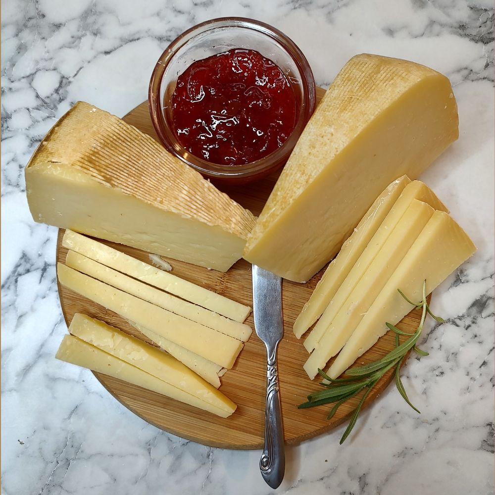 Cheese wedges with jelly on a cutting board